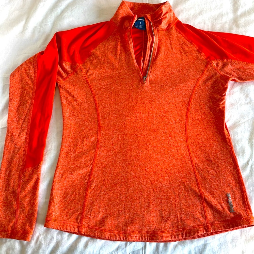 Reebok, Athletic cut, women’s long sleeve, 3/4 zip, orange top.